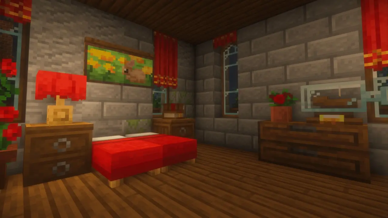 A bedroom with a red bed, a chest of drawers and a painting