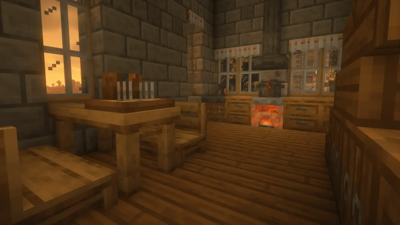 A wooden dining table and a kitchen in a cabin