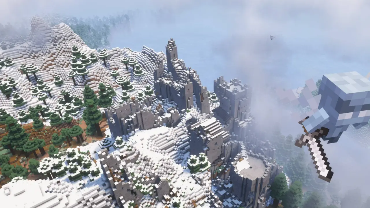 A snowy mountain range seen from a cliff